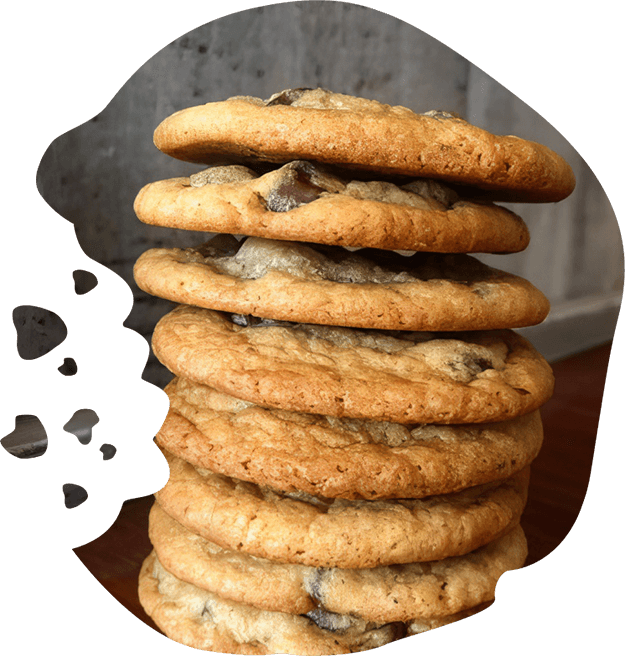 A stack of chocolate chip cookies on a table.