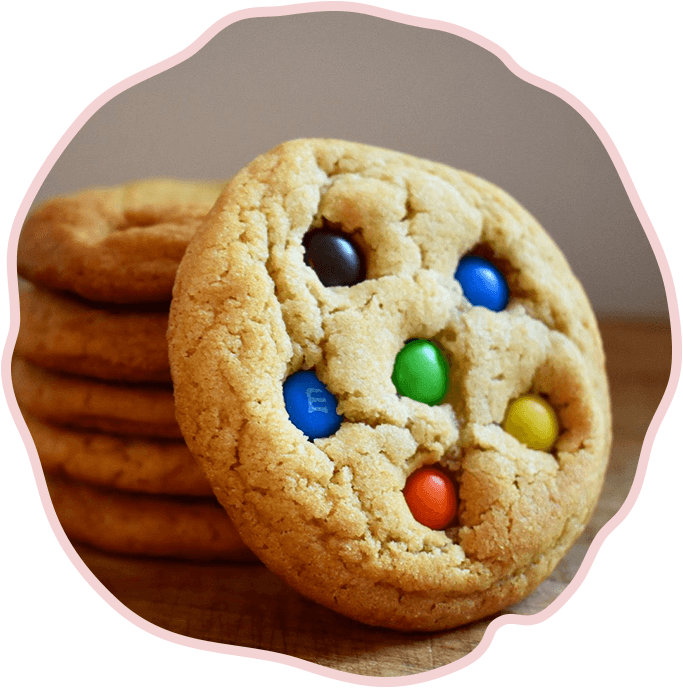 A stack of cookies with m & m's on top.
